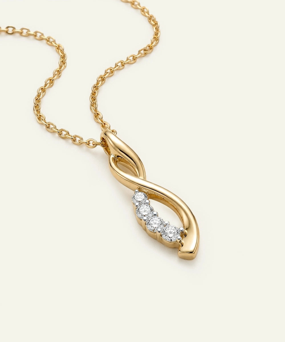 Gold necklace with a diamond pendant on a light beige background