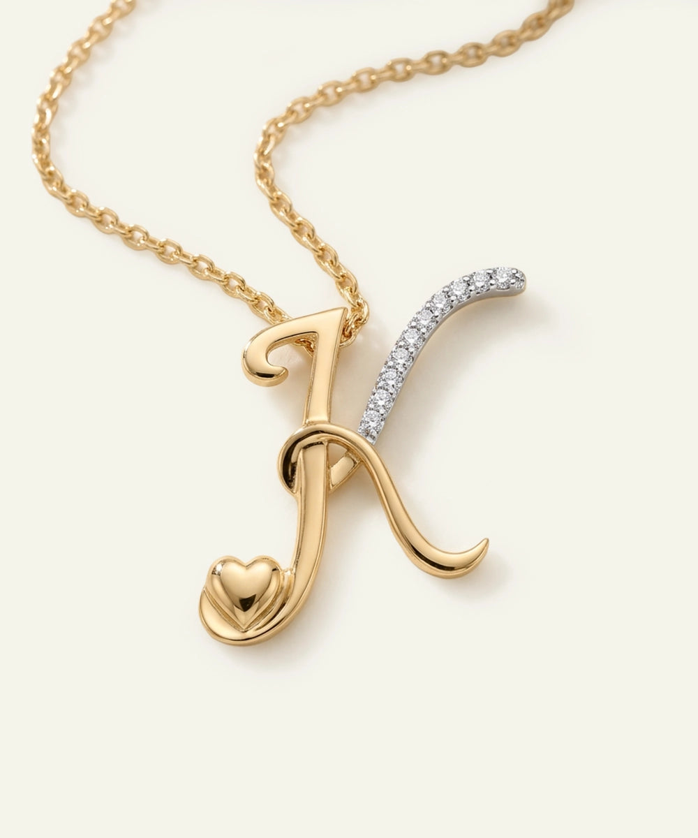 Gold necklace with a letter 'K' pendant on a white background