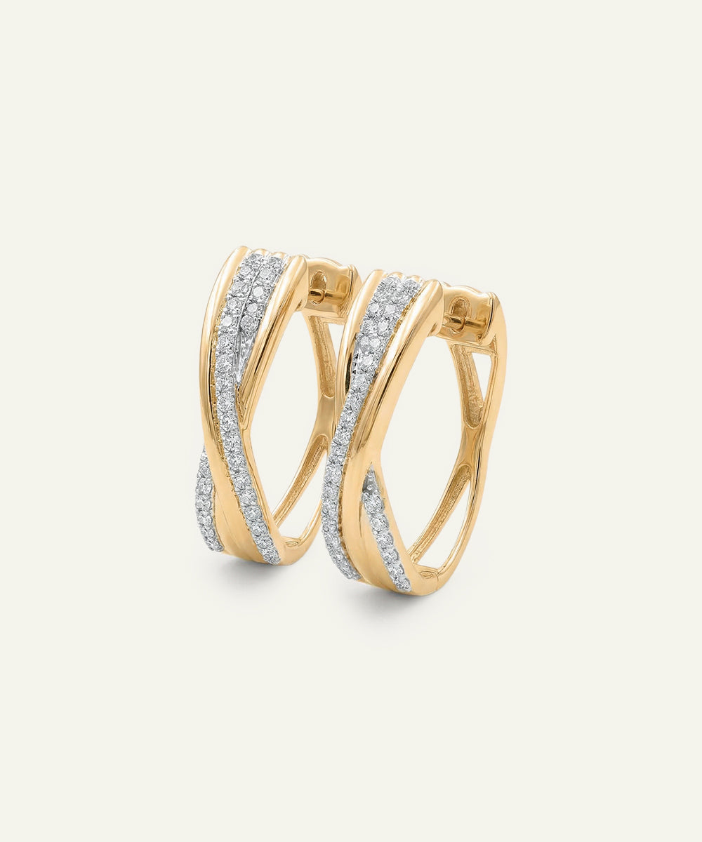 Gold hoop earrings with diamond accents on a light gray background