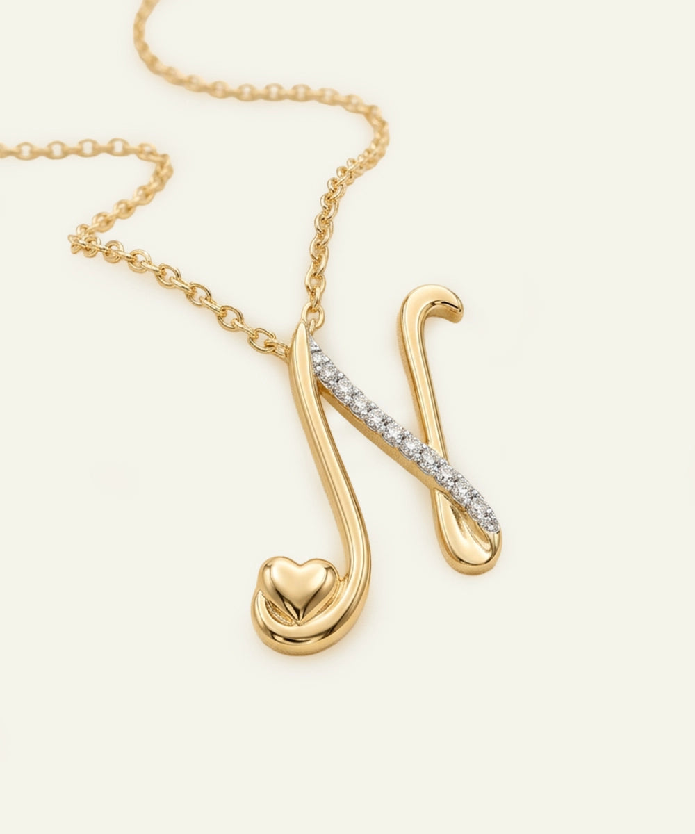 Gold necklace with a unique pendant on a light beige background