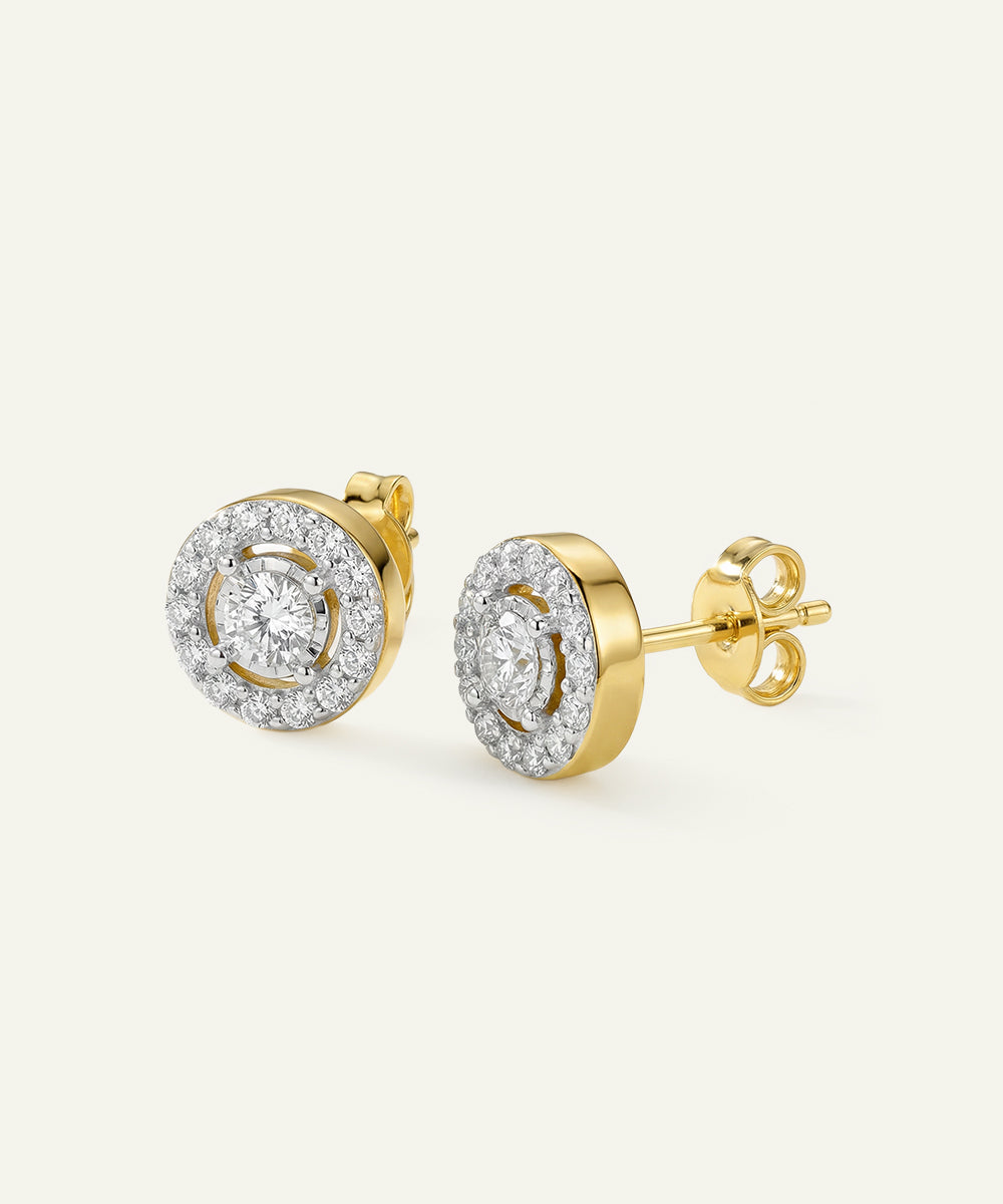 Gold earrings with diamond accents on a white background