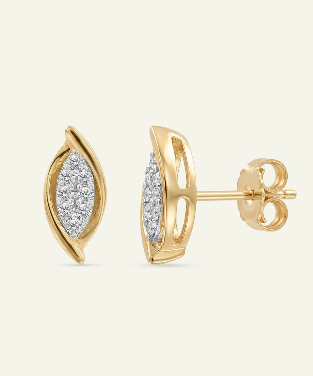 Gold earrings with diamond accents on a beige background