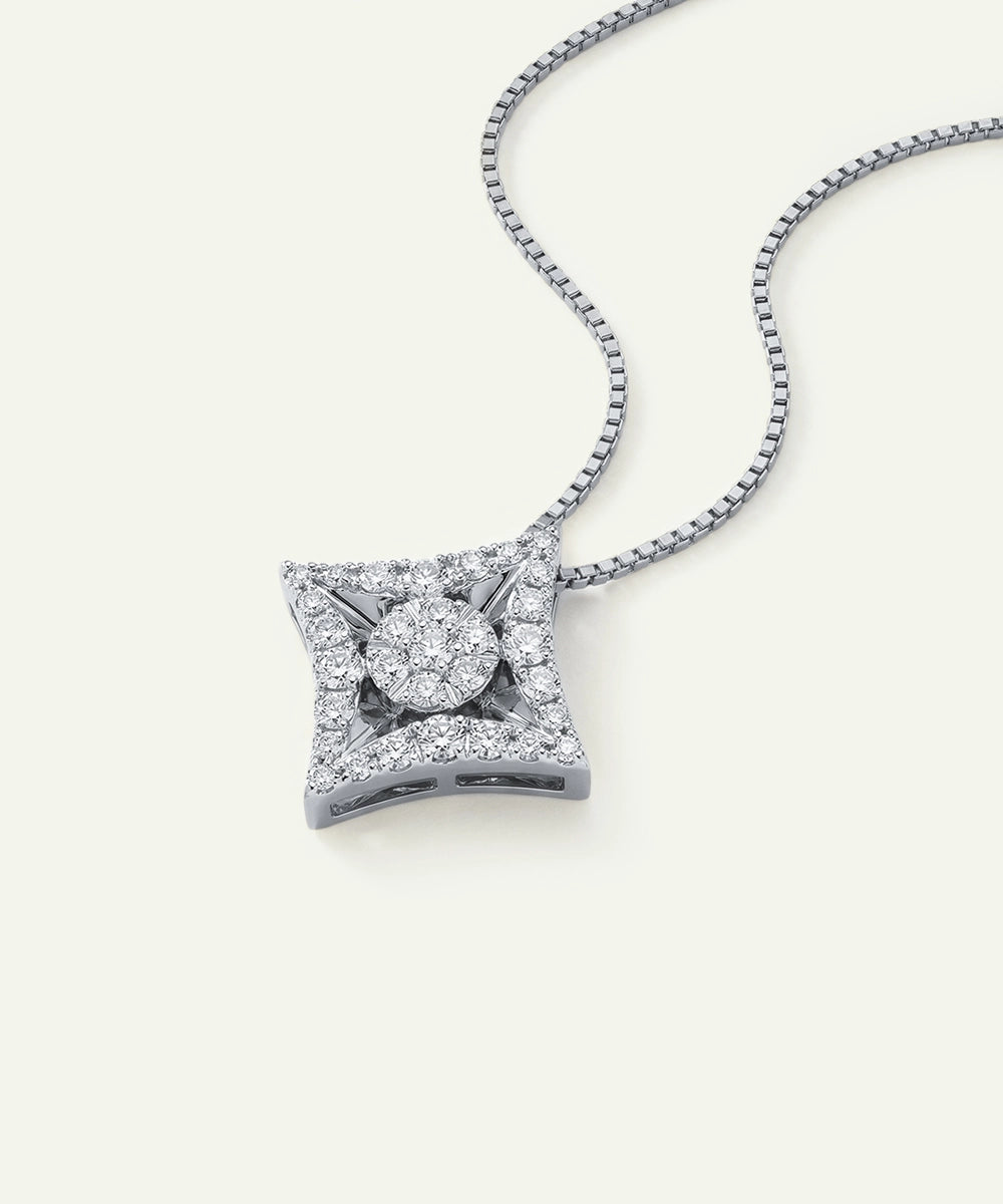 White gold geometric kite pendant necklace with round diamond cluster.