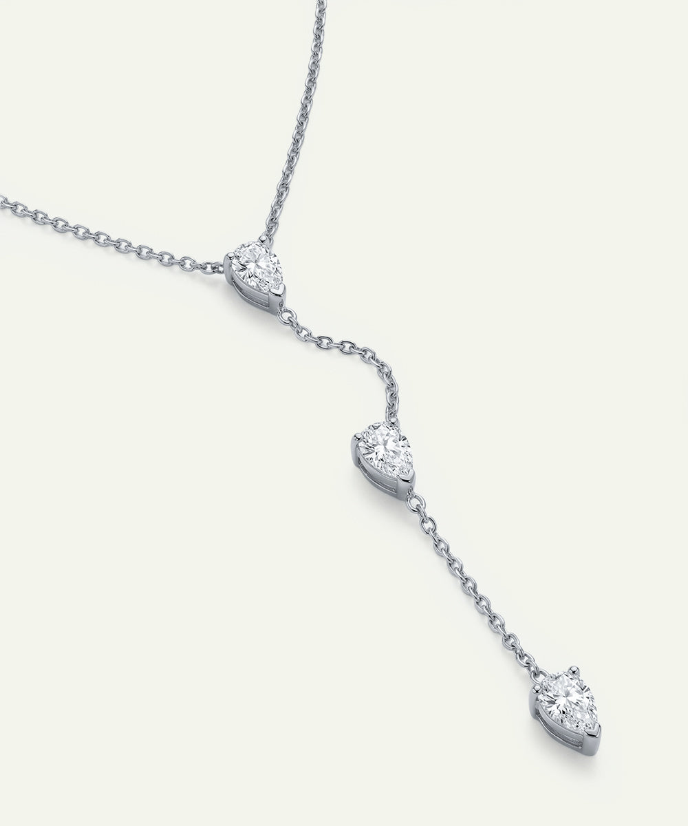 Diamond necklace with heart-shaped pendants on a white background