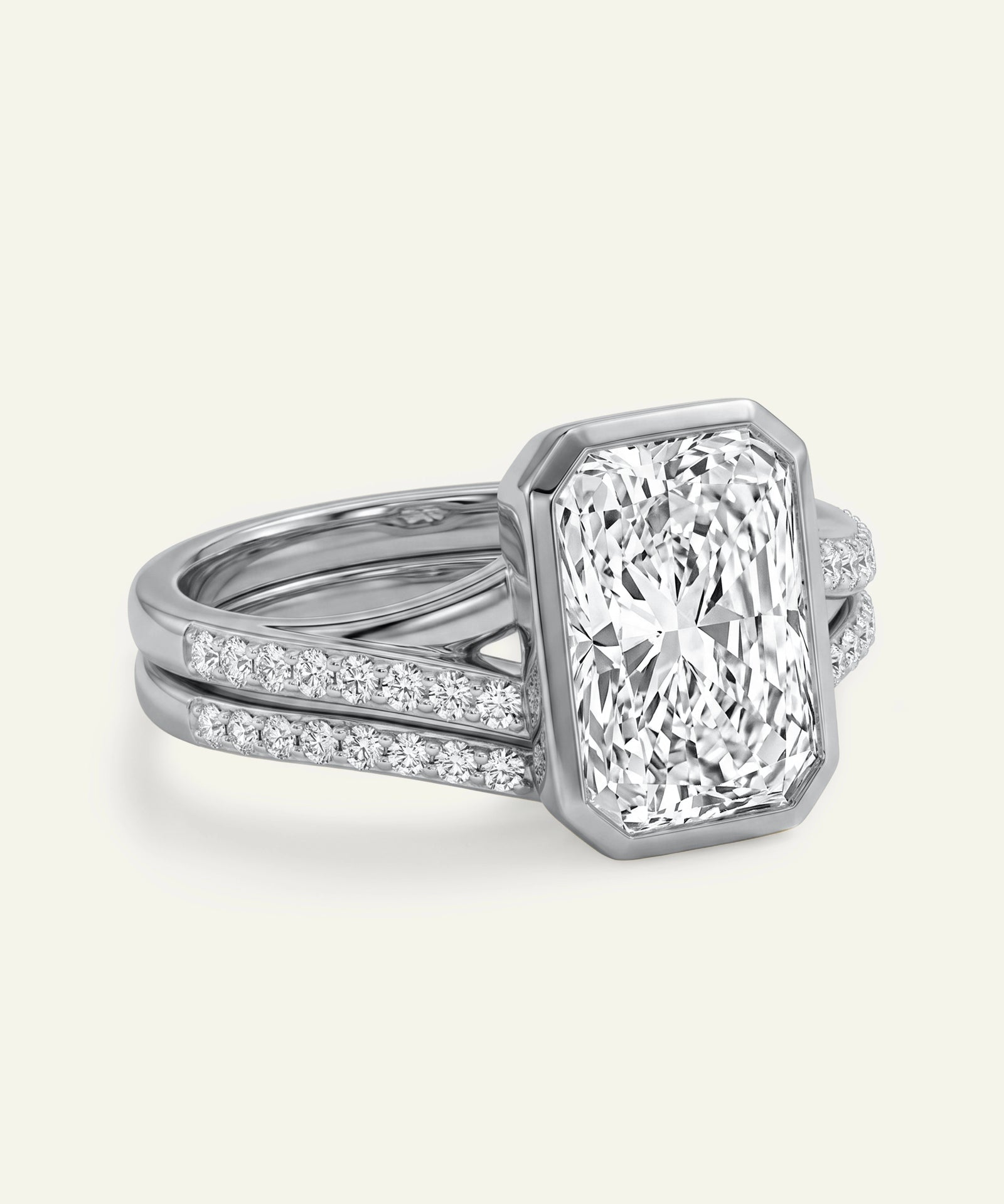 Diamond ring with a white gold band on a light gray background