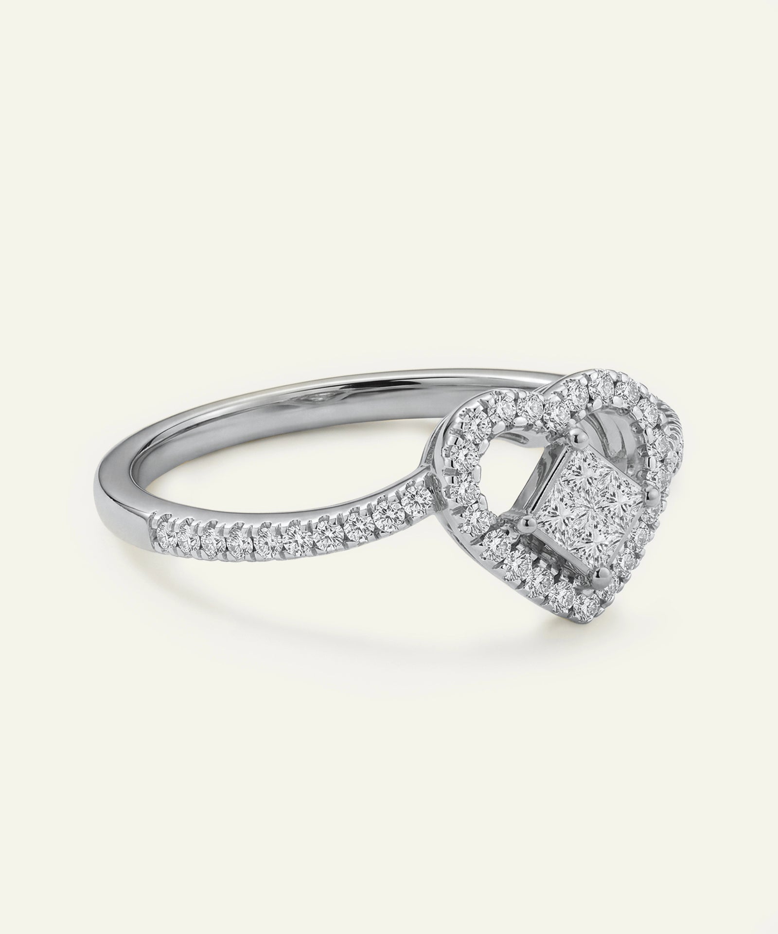 Silver ring with a heart-shaped diamond on a white background