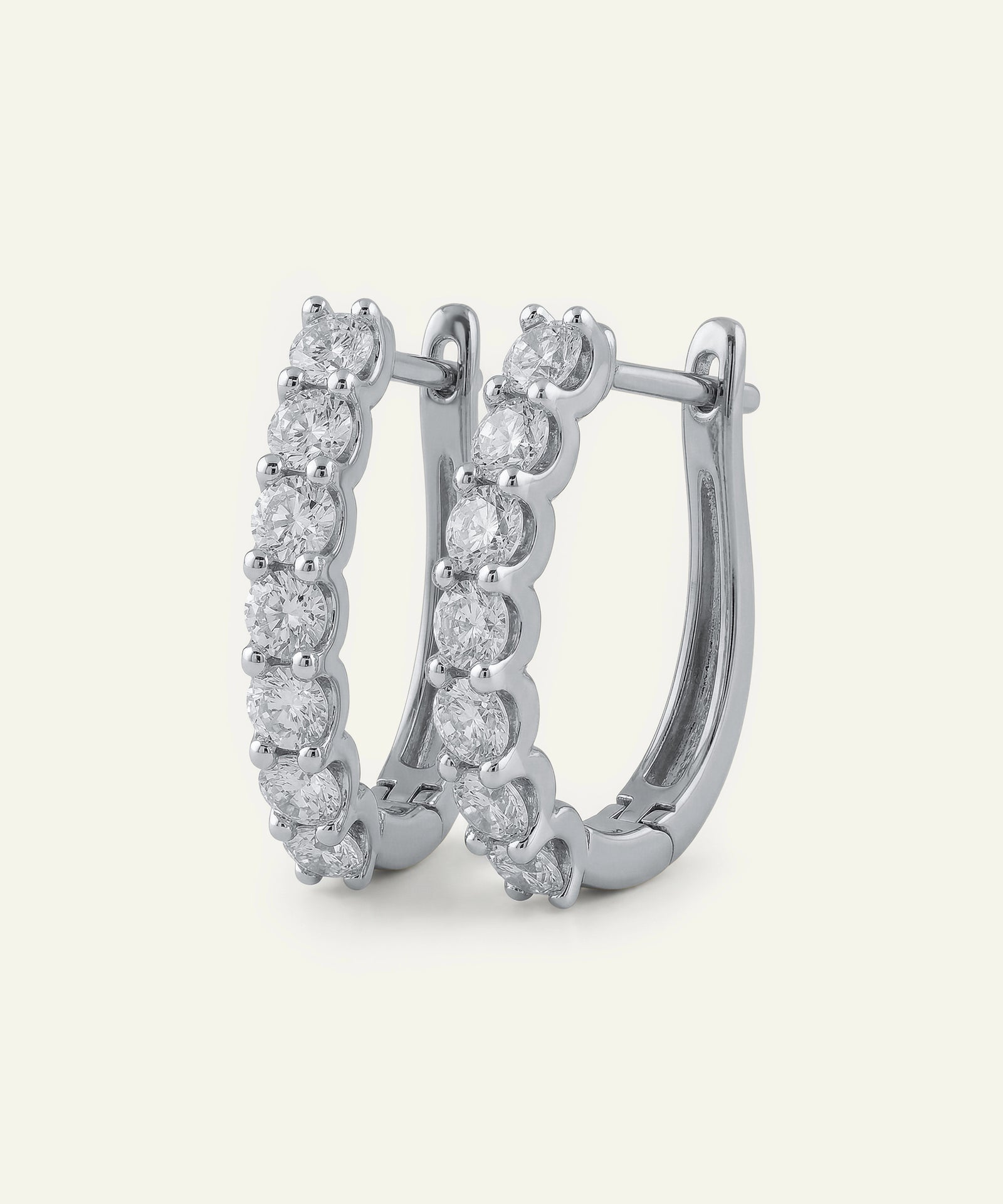 Pair of diamond hoop earrings on a white background