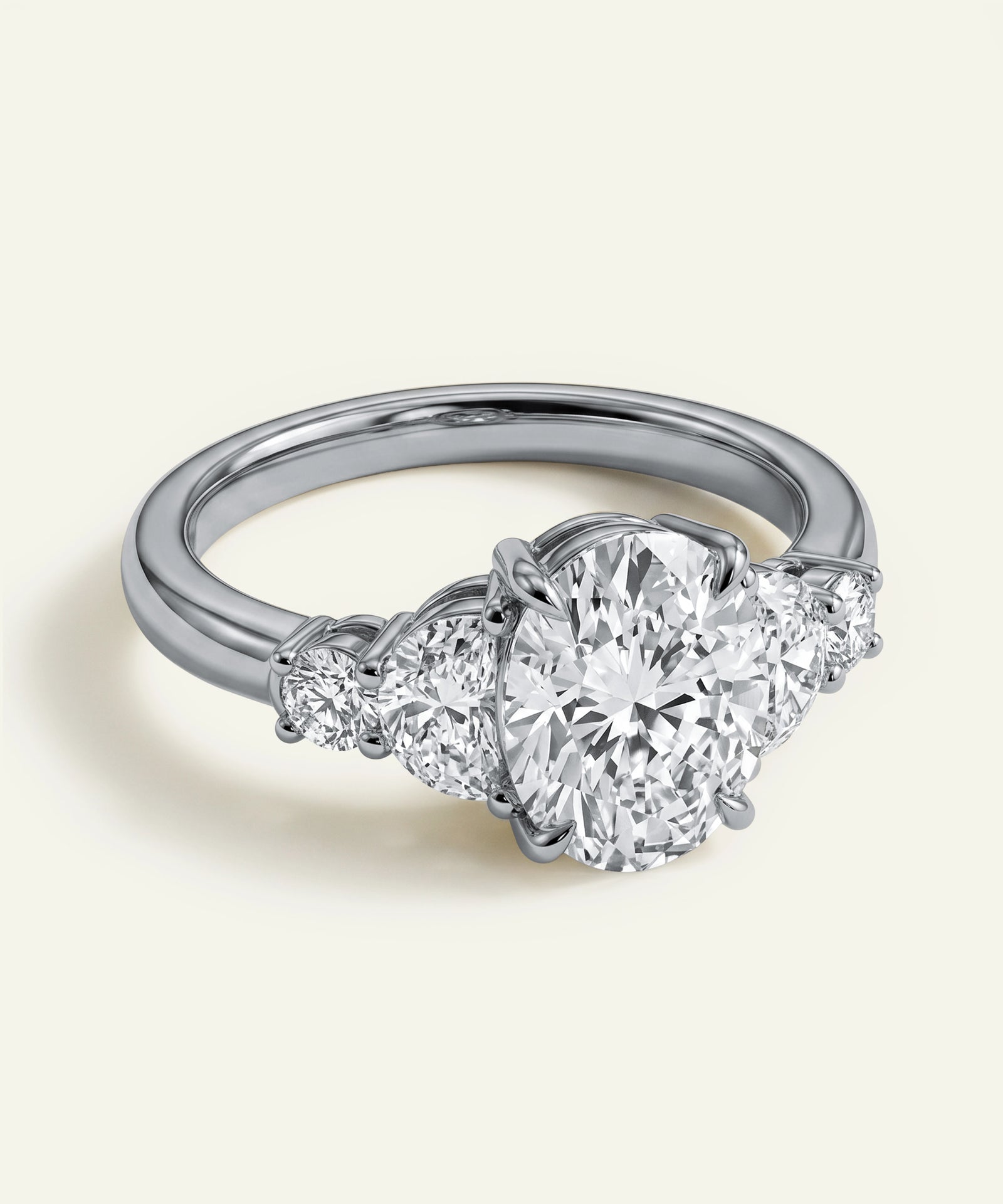 Diamond ring with three circular diamonds on a light background
