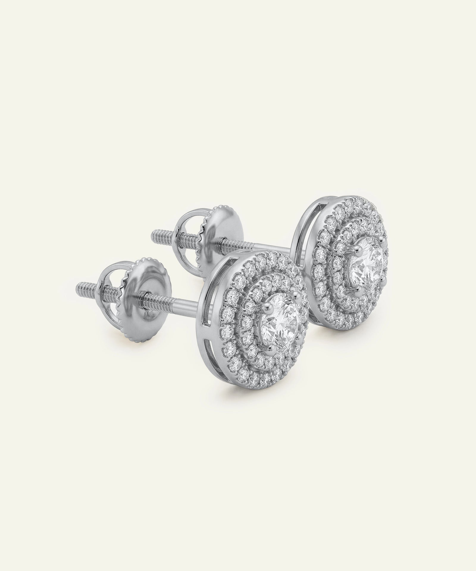 Pair of silver earrings with clear gemstones on a white background