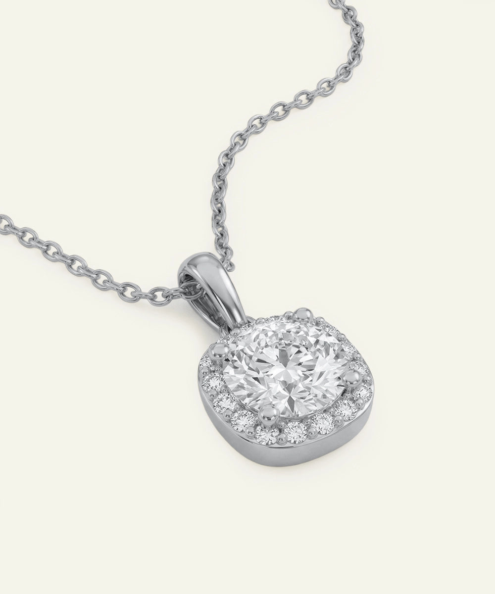 Diamond pendant on a chain against a white background