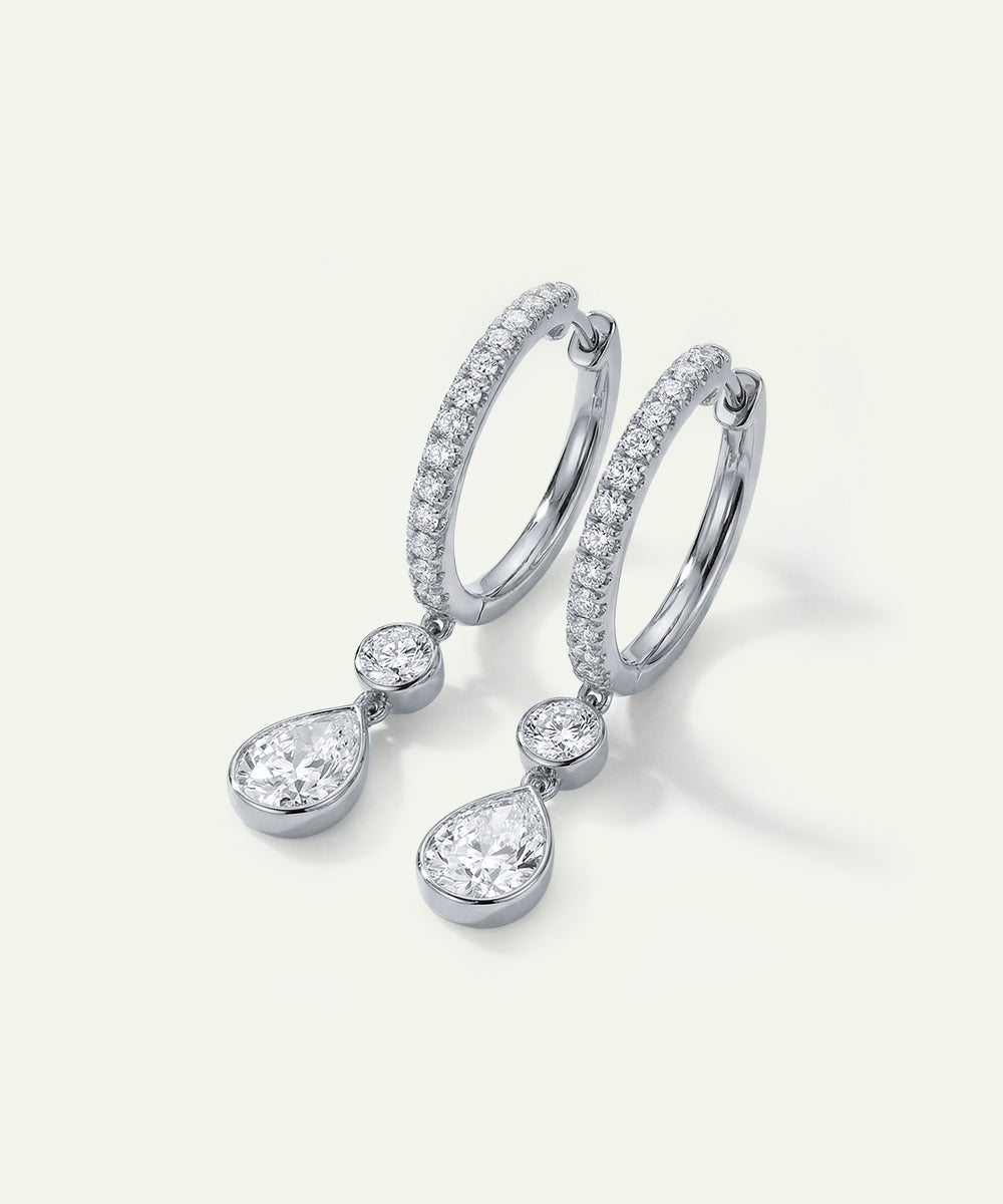 Diamond earrings on a light gray background