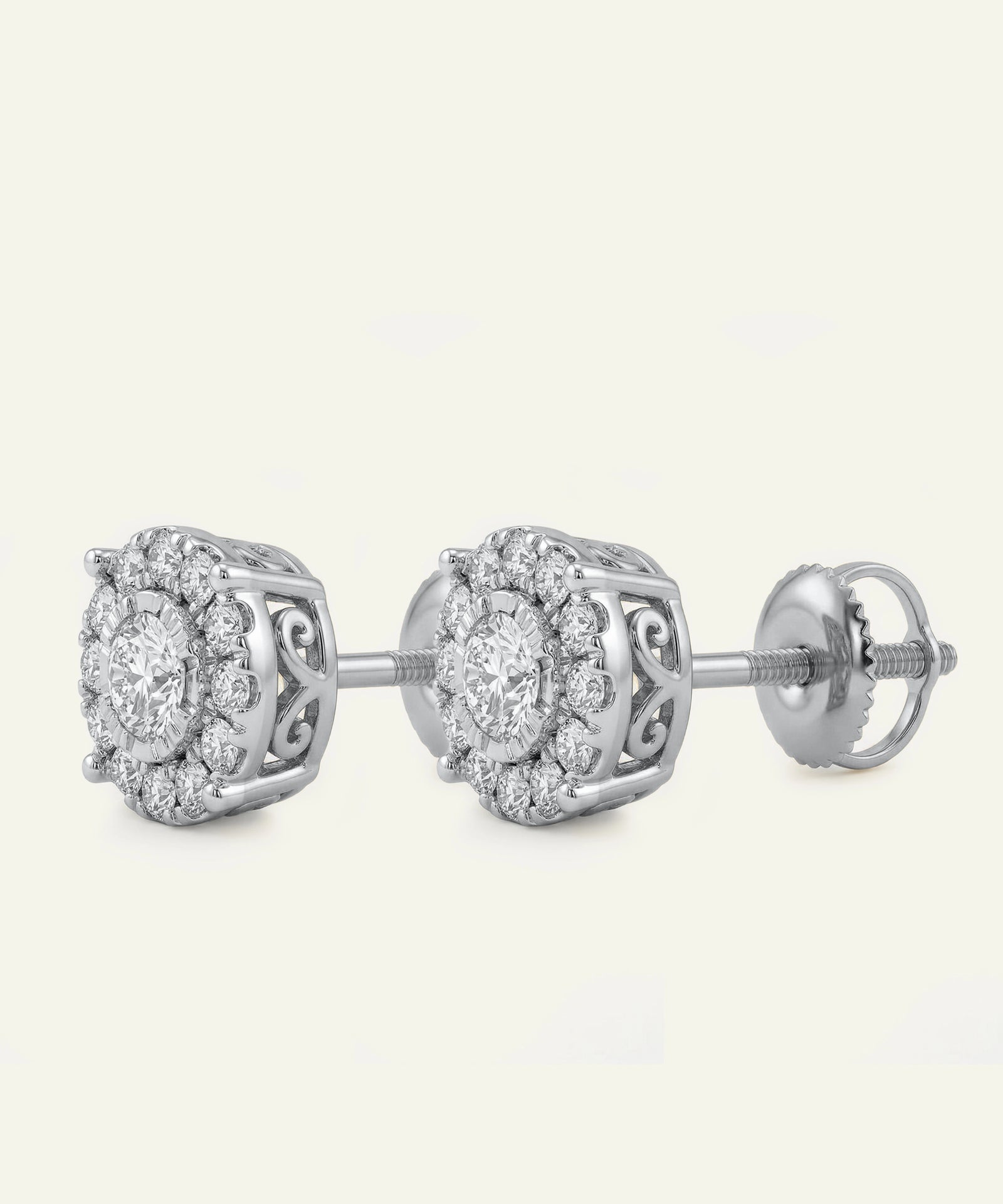 Pair of silver earrings with diamond-like stones on a white background