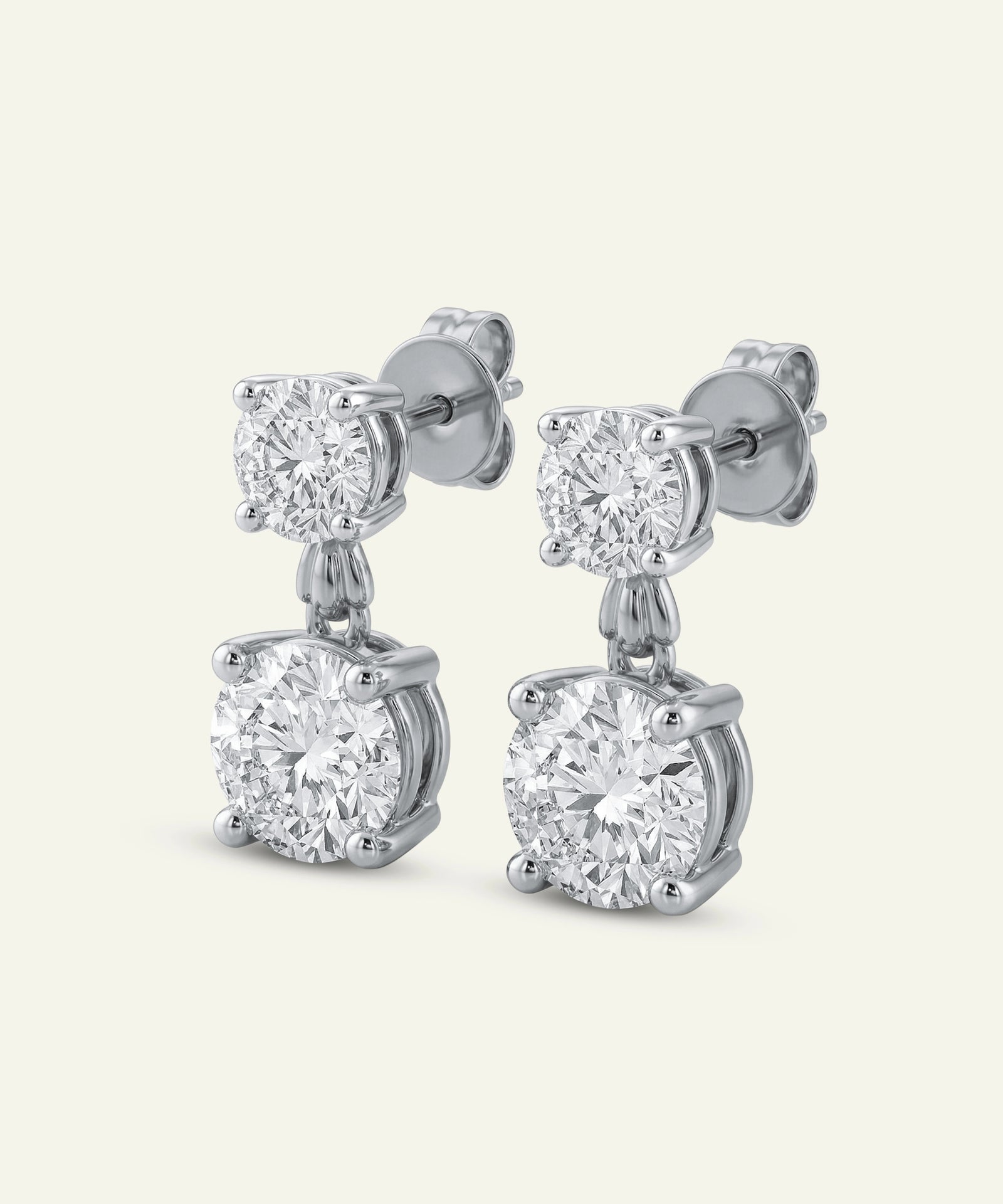 Pair of diamond earrings on a light gray background