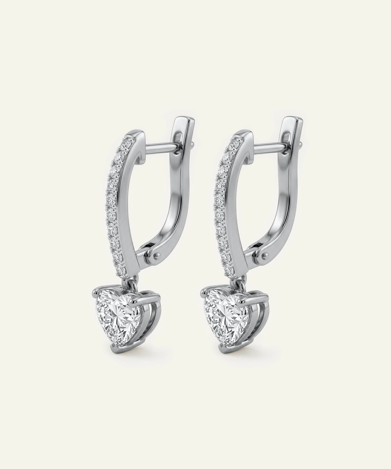 Pair of diamond earrings on a light gray background