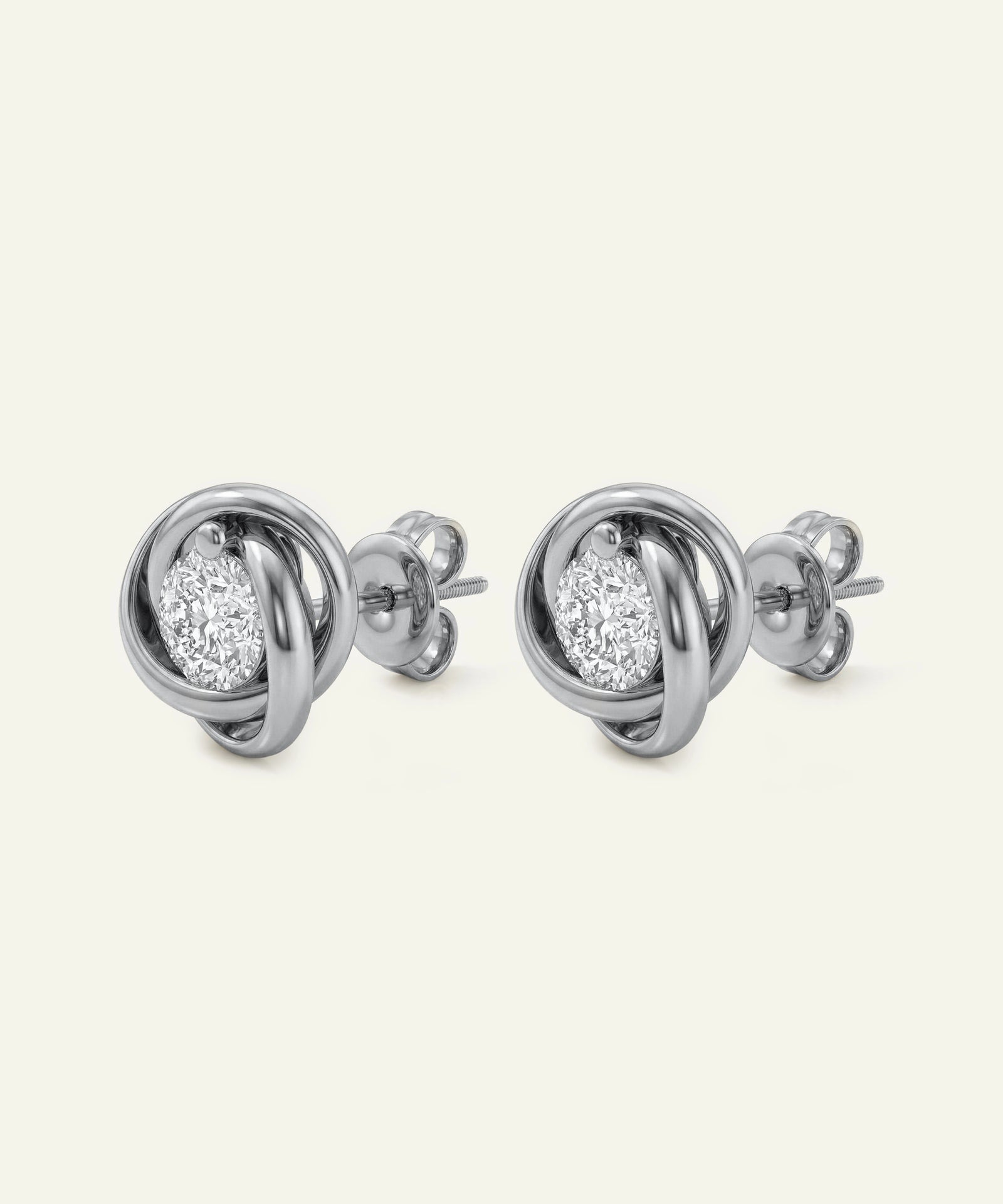 Pair of silver spherical earrings on a white background
