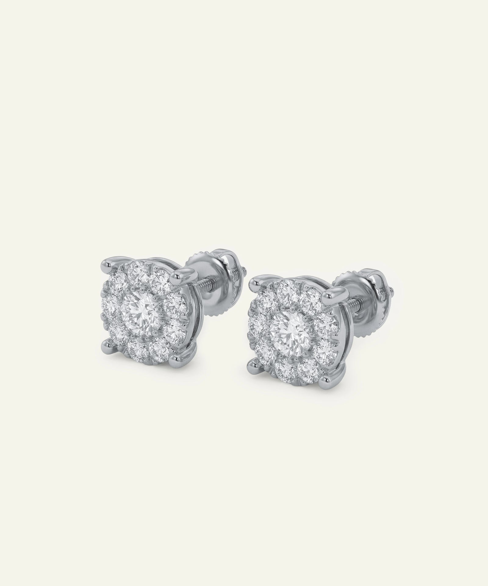 Pair of silver stud earrings with clear gemstones on a light gray background