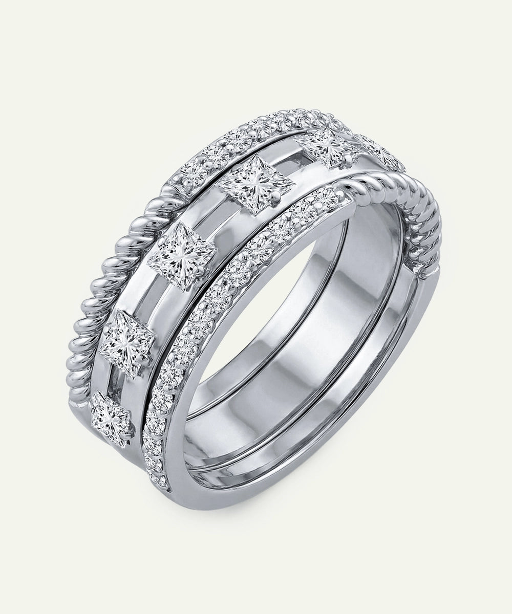 Silver ring with diamond accents on a light gray background