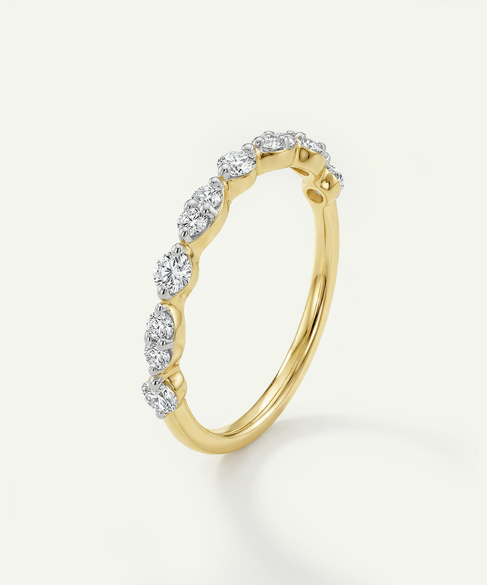 Gold ring with diamonds on a light gray background