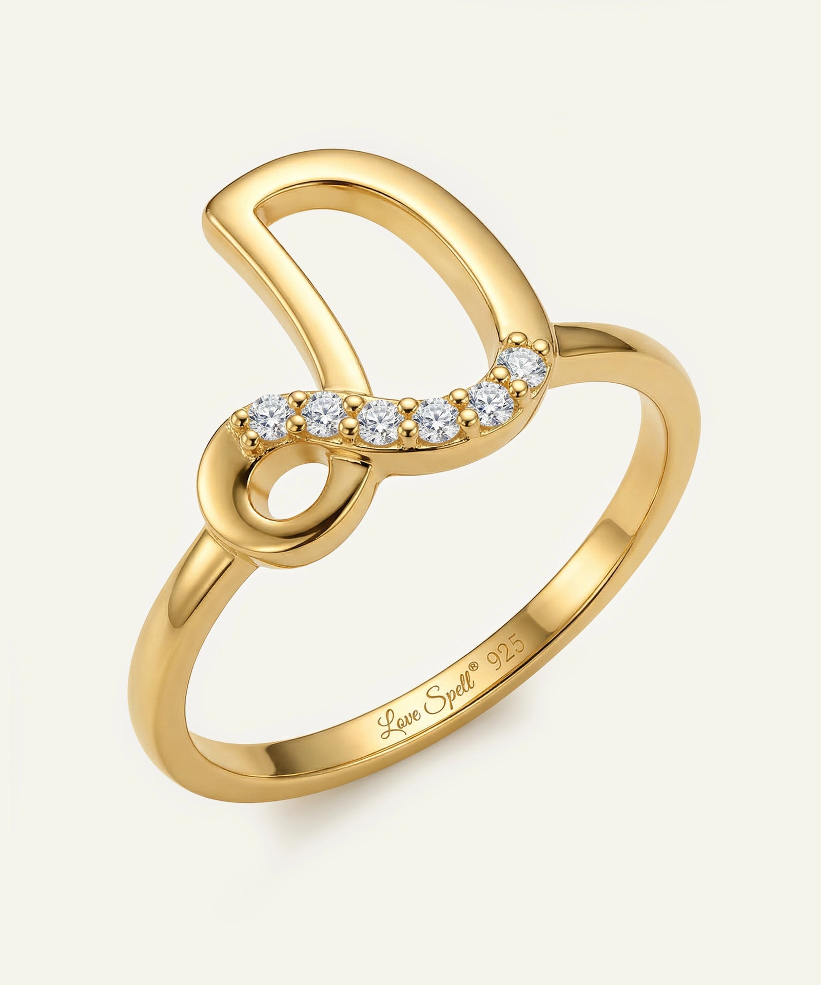 Gold ring with diamond accents on a white background