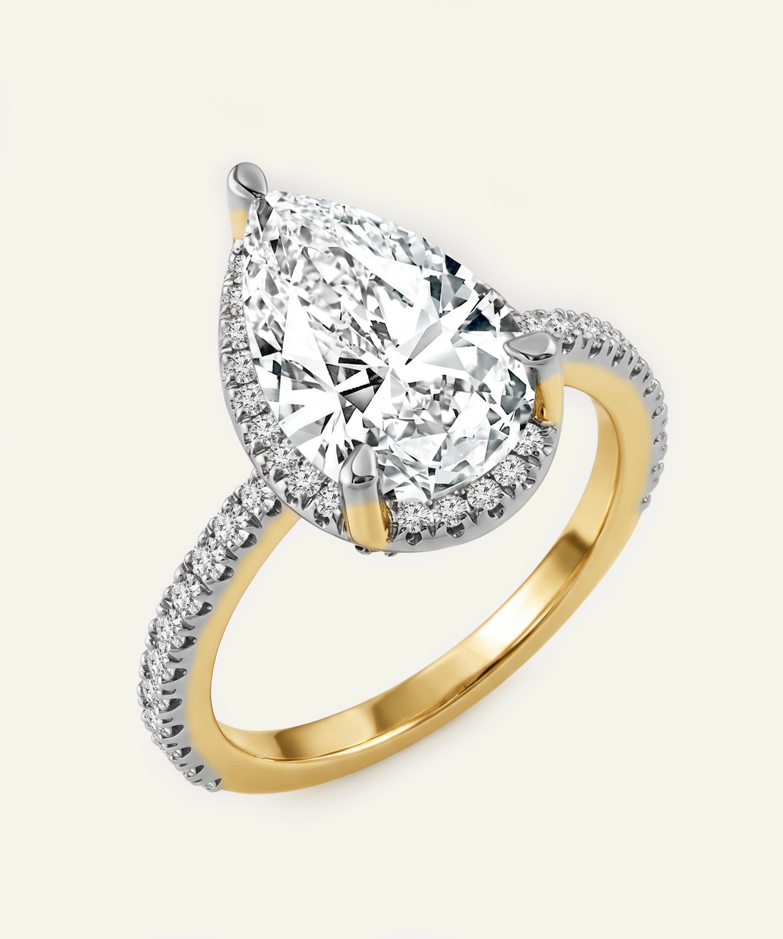 Gold and silver ring with a large diamond and smaller diamonds on the band against a white background