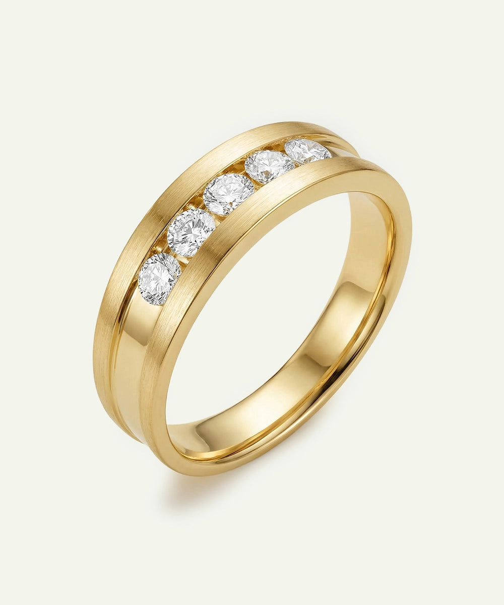 Gold ring with embedded diamonds on a light gray background
