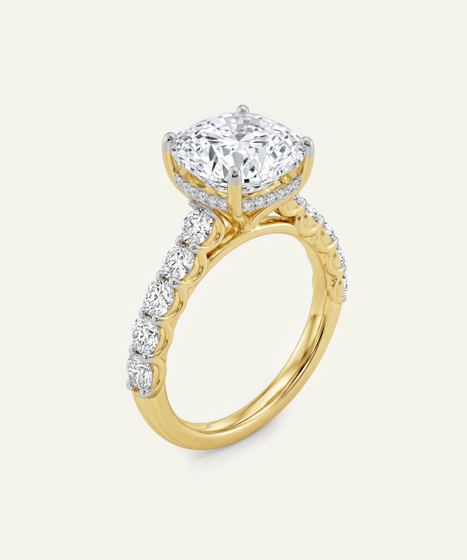 Gold ring with a large diamond and smaller diamonds on the band against a white background