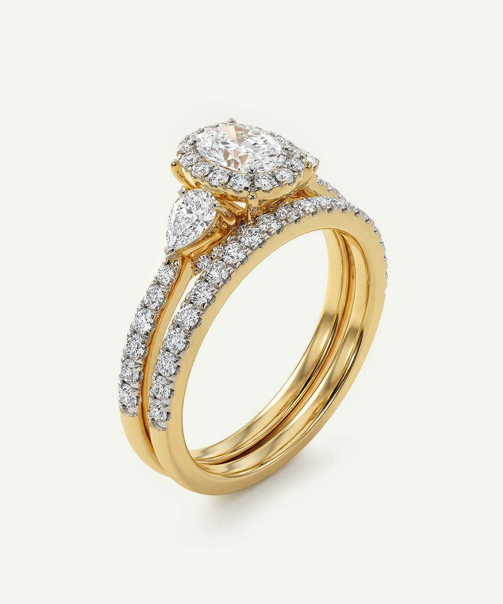 Gold ring with diamond accents on a white background