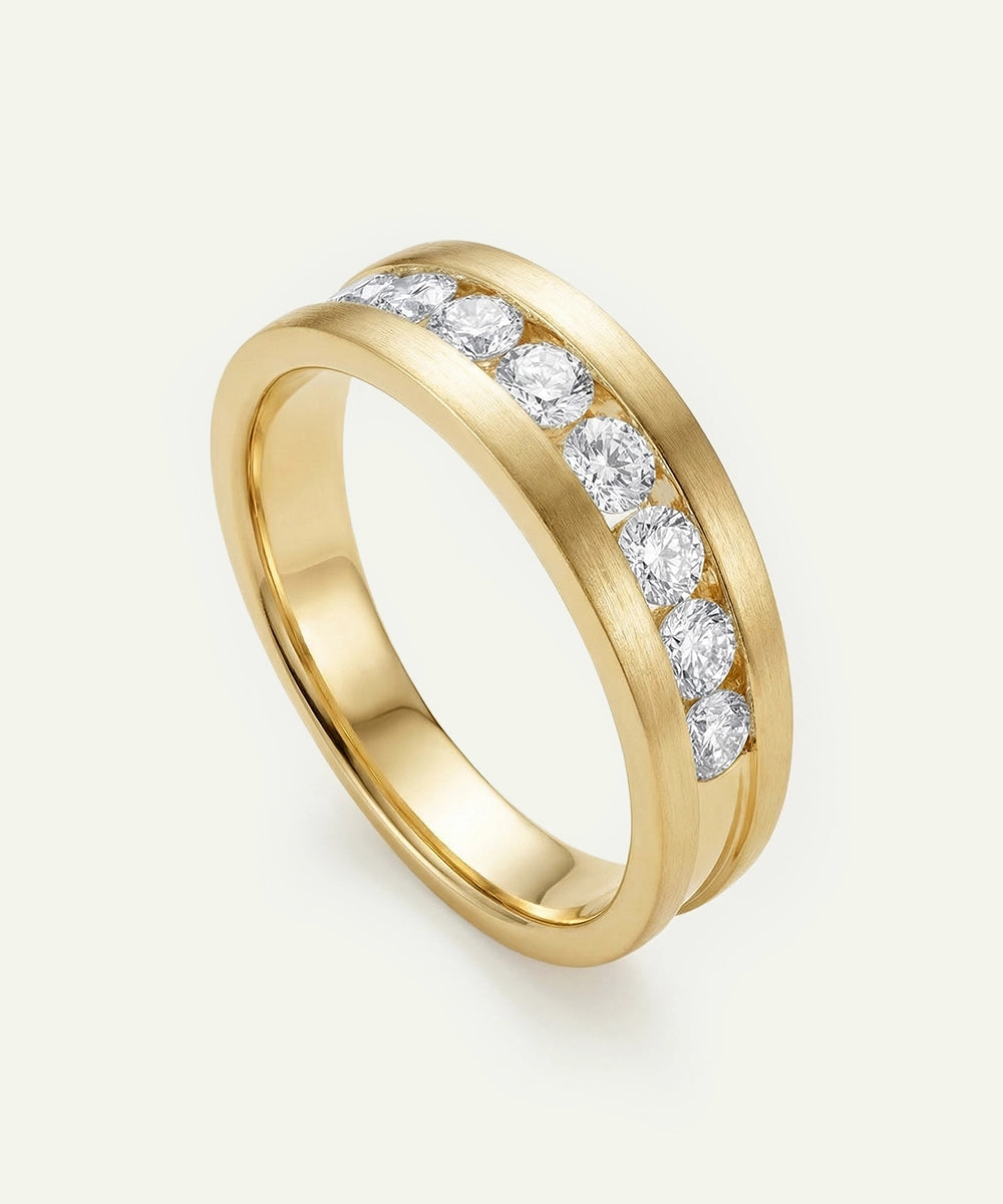 Gold ring with diamonds on a light beige background