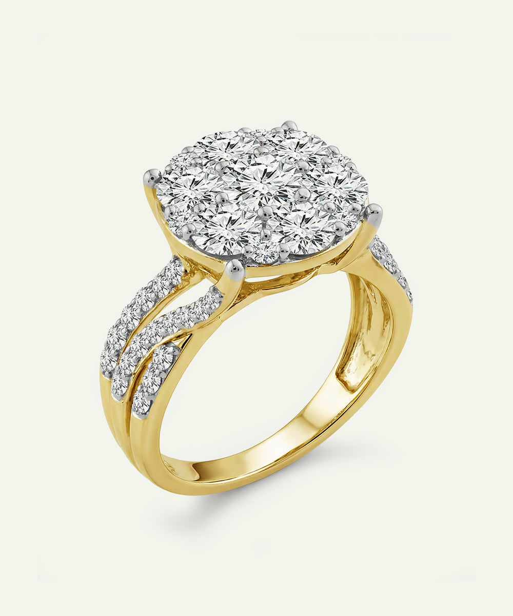 Gold ring with a large diamond and smaller diamonds on the band against a white background