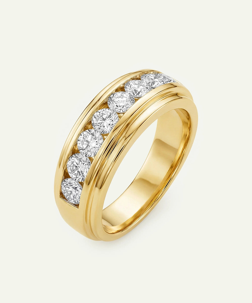 Gold ring with diamonds on a light gray background