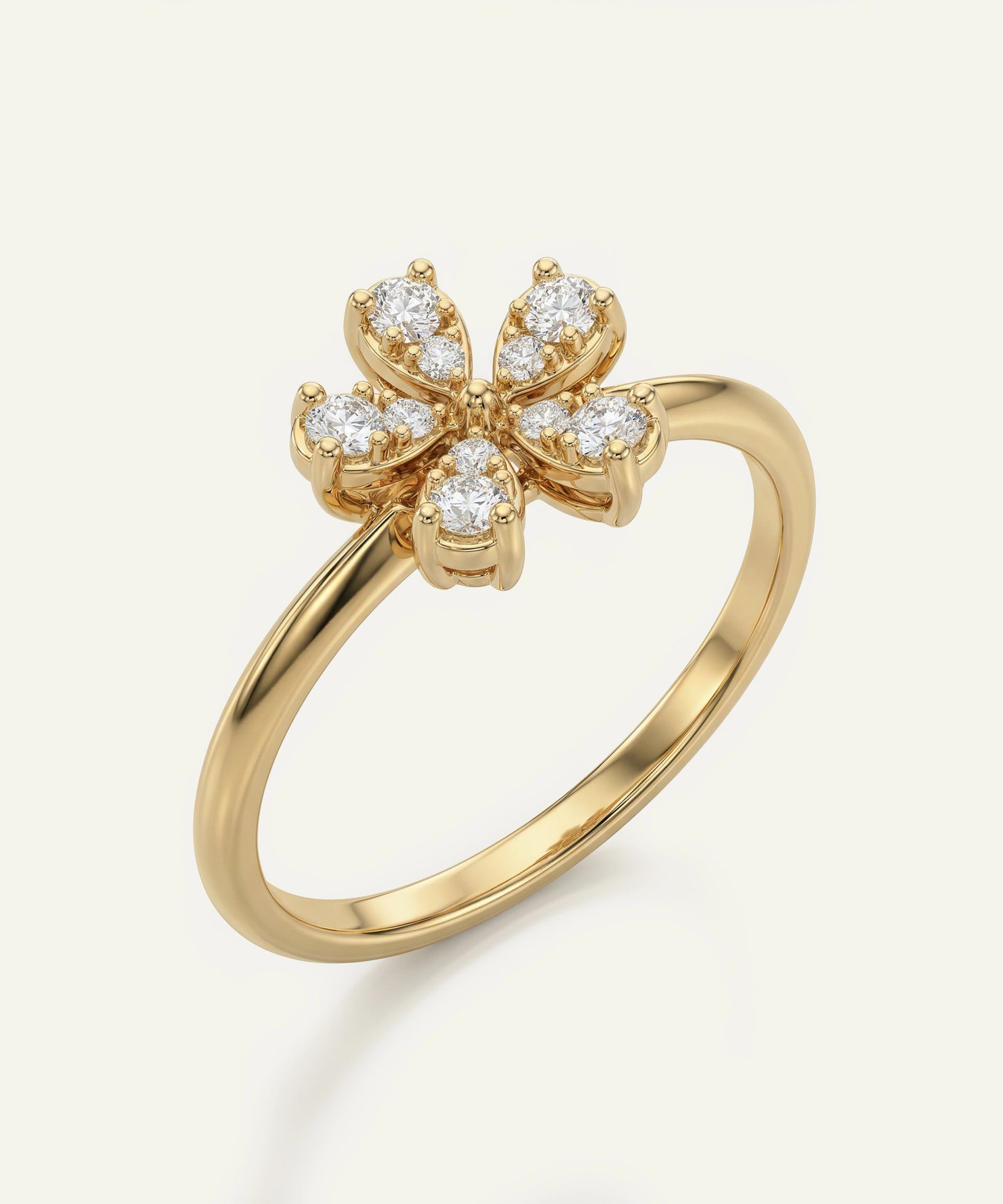 Gold ring with diamond flower design on a white background