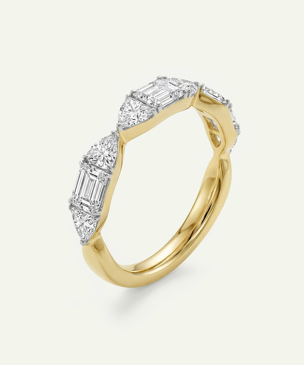 Gold ring with diamond accents on a light gray background