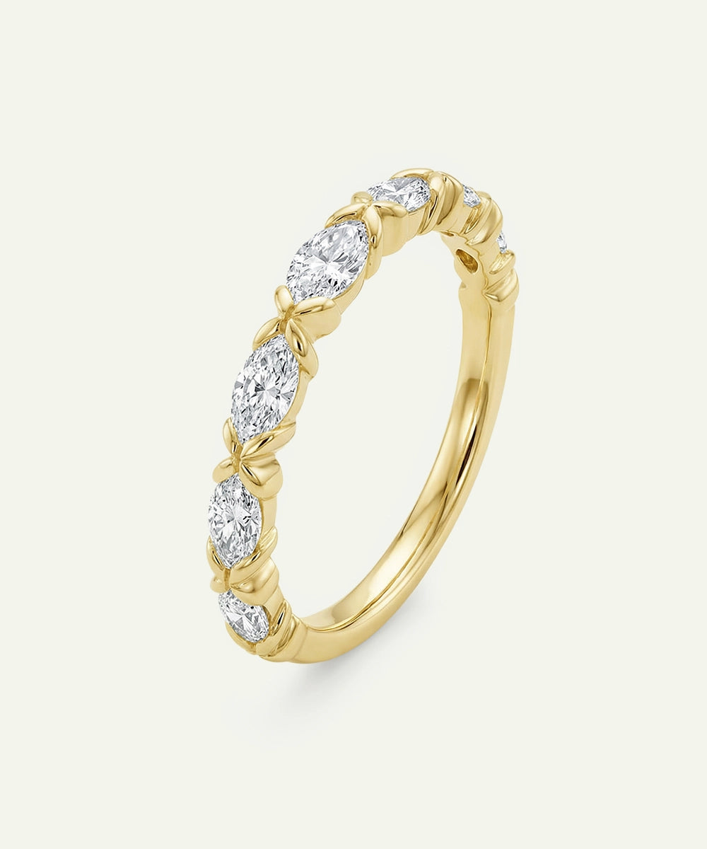 Gold ring with diamonds on a light beige background