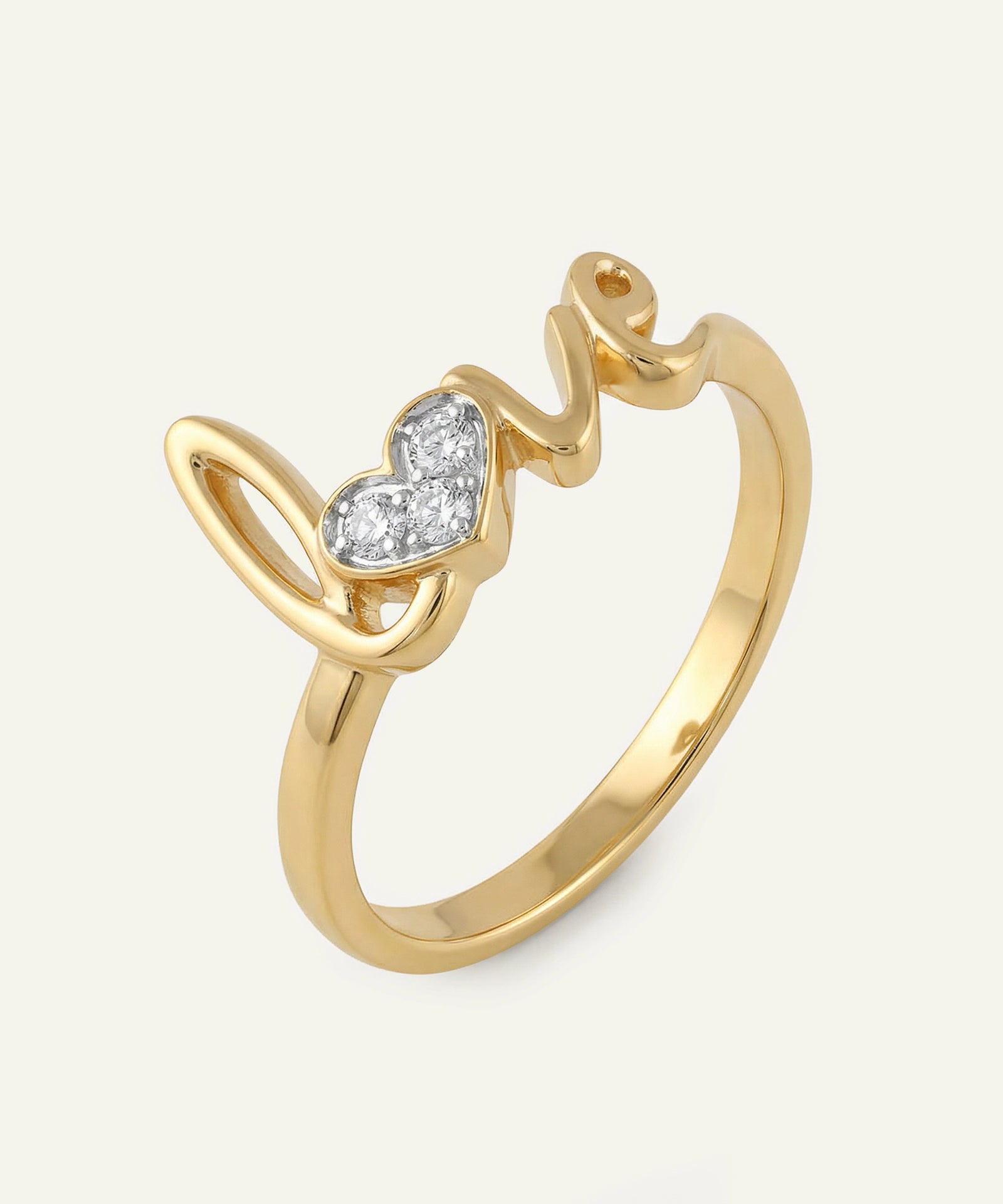 Gold ring with a heart-shaped diamond on a light beige background