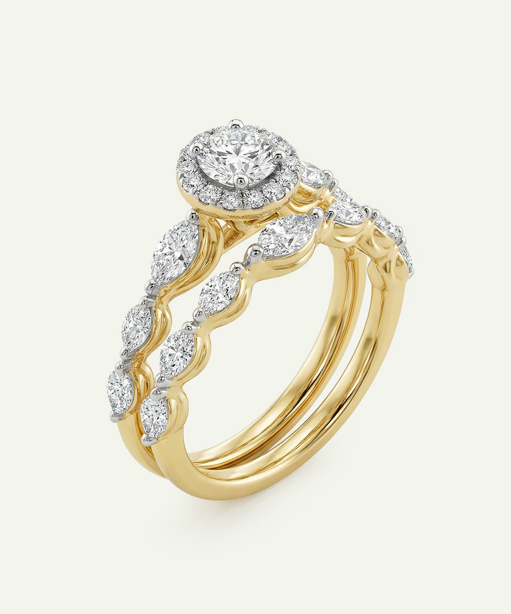 Gold ring with diamond accents on a light gray background