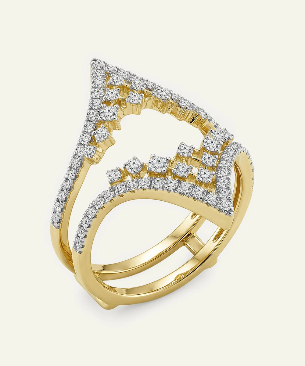 Gold ring with diamond accents on a light beige background