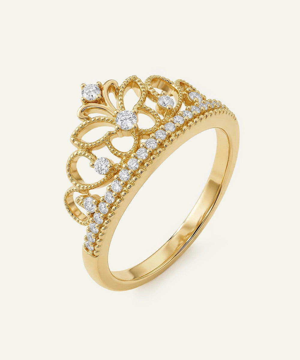 Gold ring with diamond accents on a white background