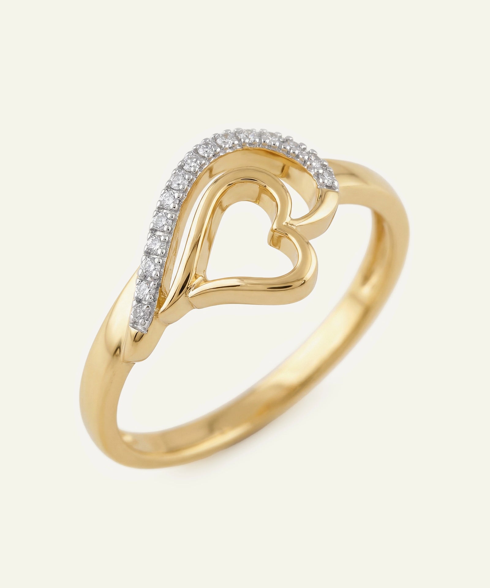 Gold heart-shaped ring with diamond accents on a white background