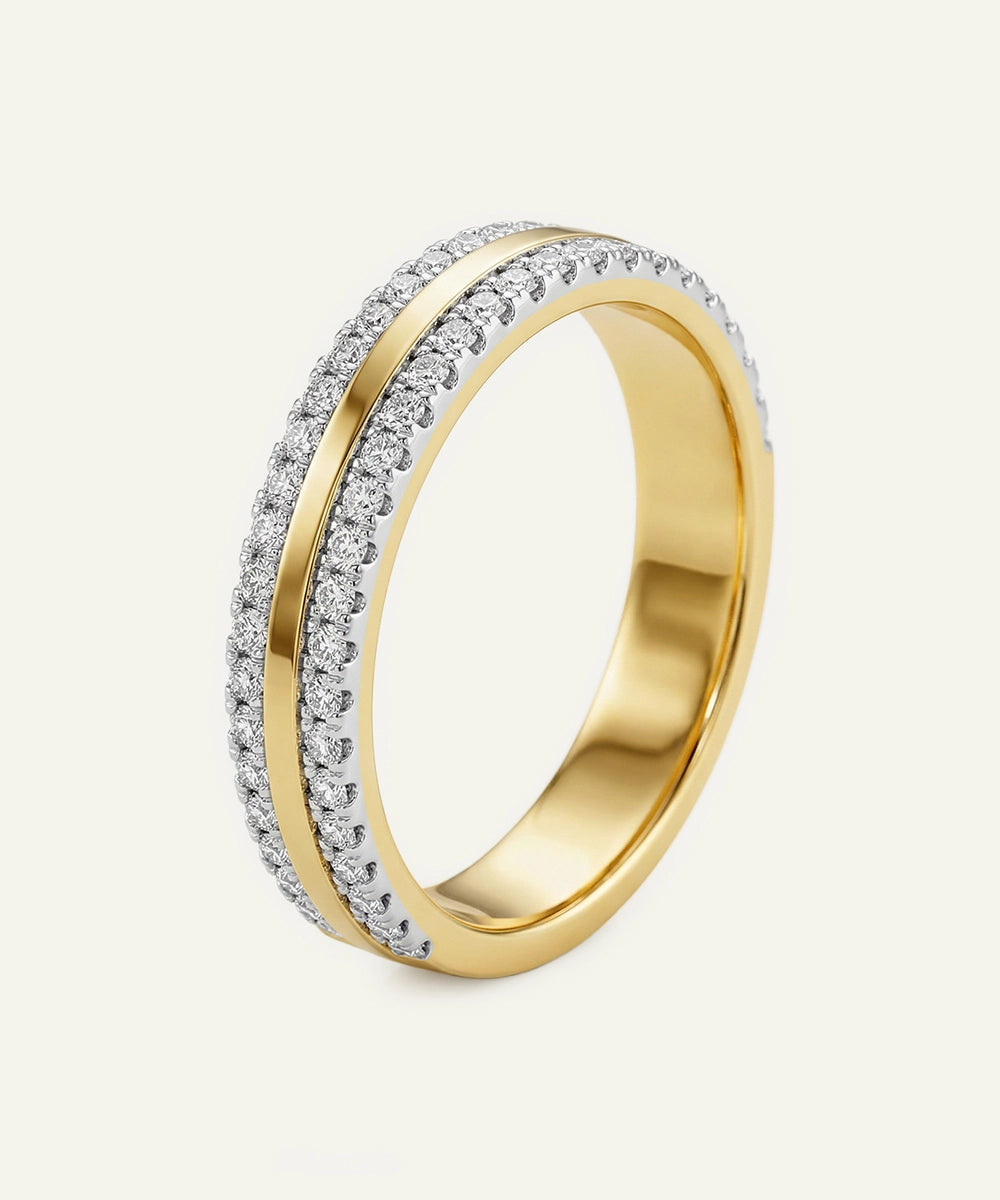 Gold ring with diamond accents on a light gray background