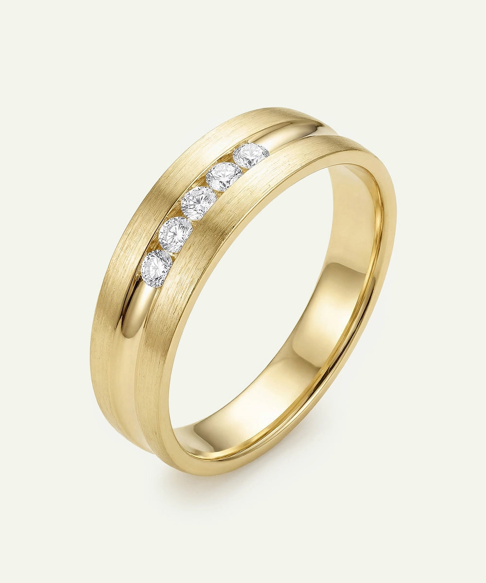 Gold ring with embedded diamonds on a light gray background