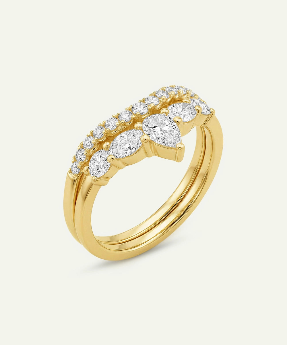 Gold ring with diamonds on a light gray background