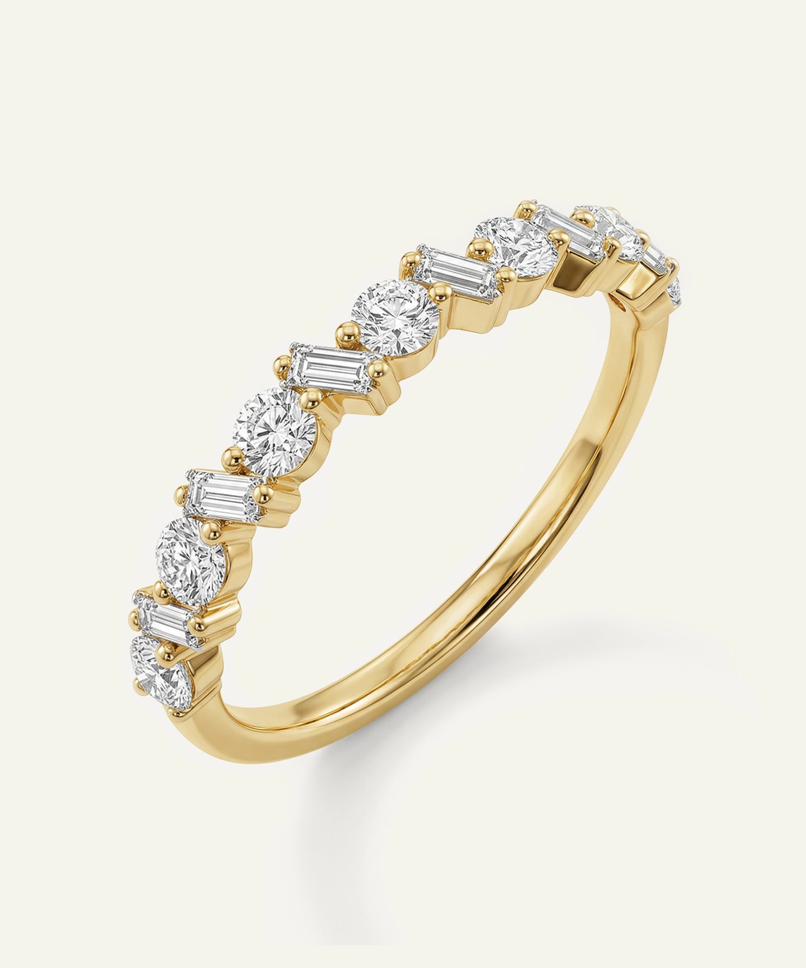 Gold ring with diamonds on a light gray background