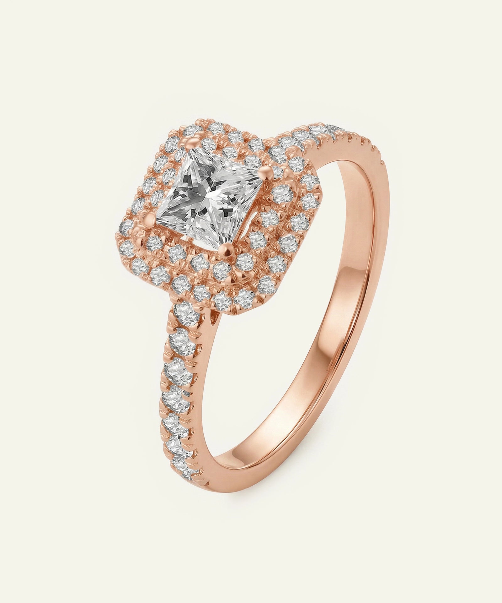 Rose gold ring with a central diamond and smaller diamonds on a light beige background