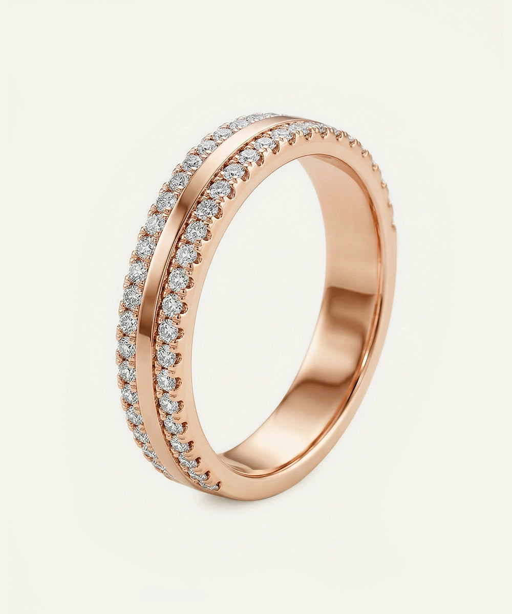 Rose gold ring with diamond accents on a light beige background