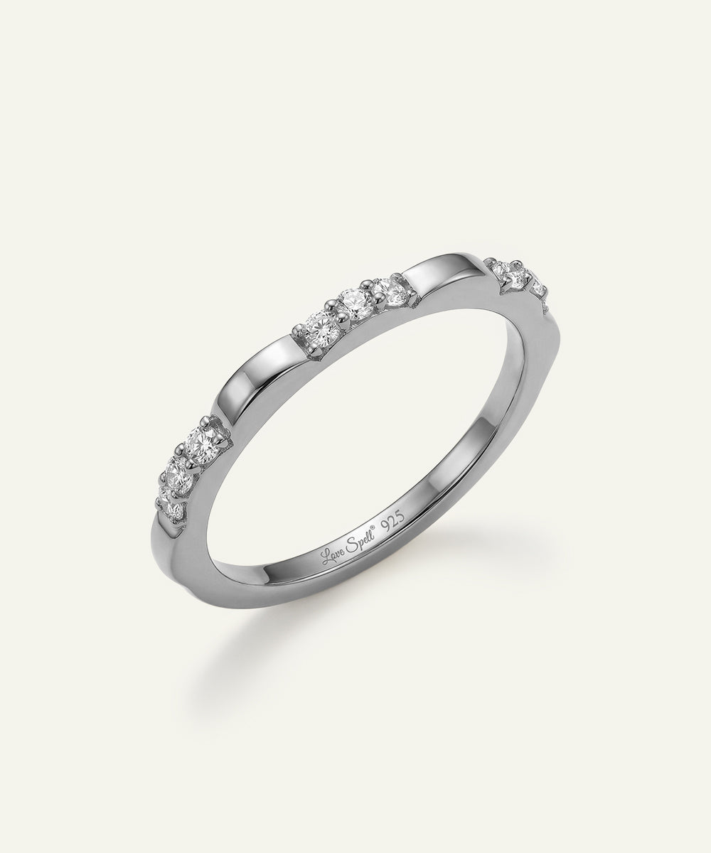 Silver ring with small diamonds on a white background
