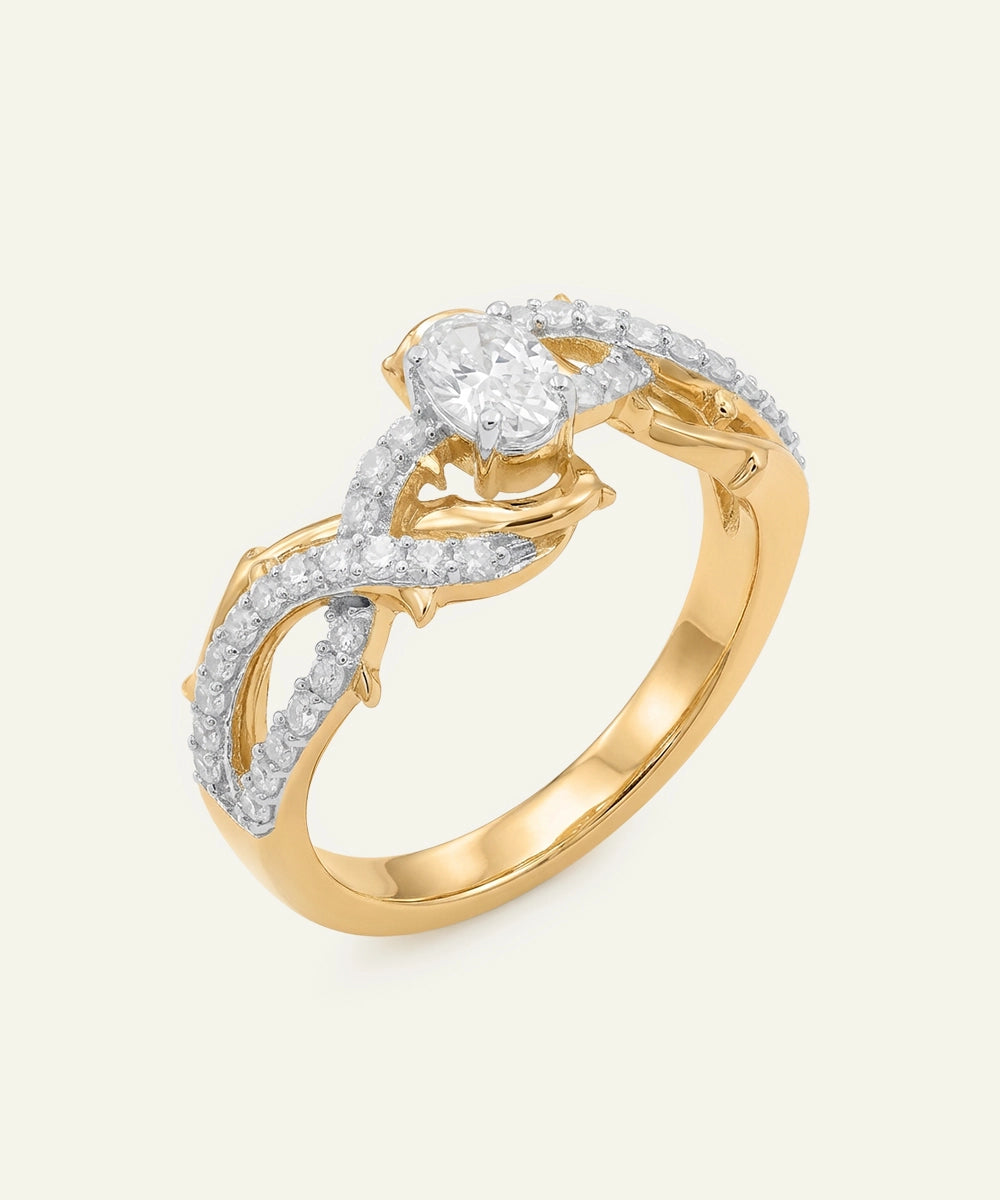 Gold ring with a heart-shaped diamond and smaller diamonds on a beige background