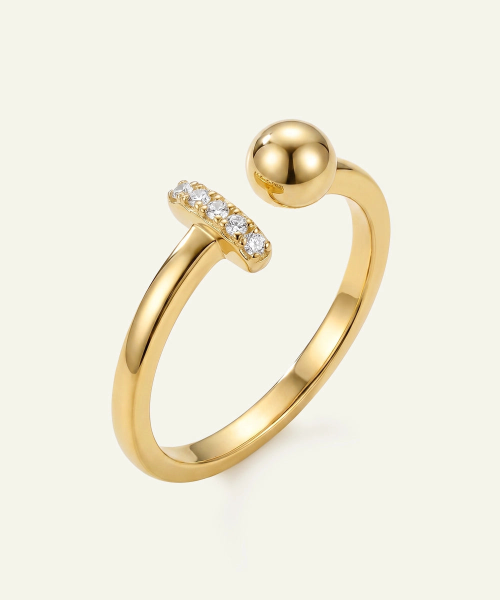 Gold ring with a spherical design and small diamonds on a white background