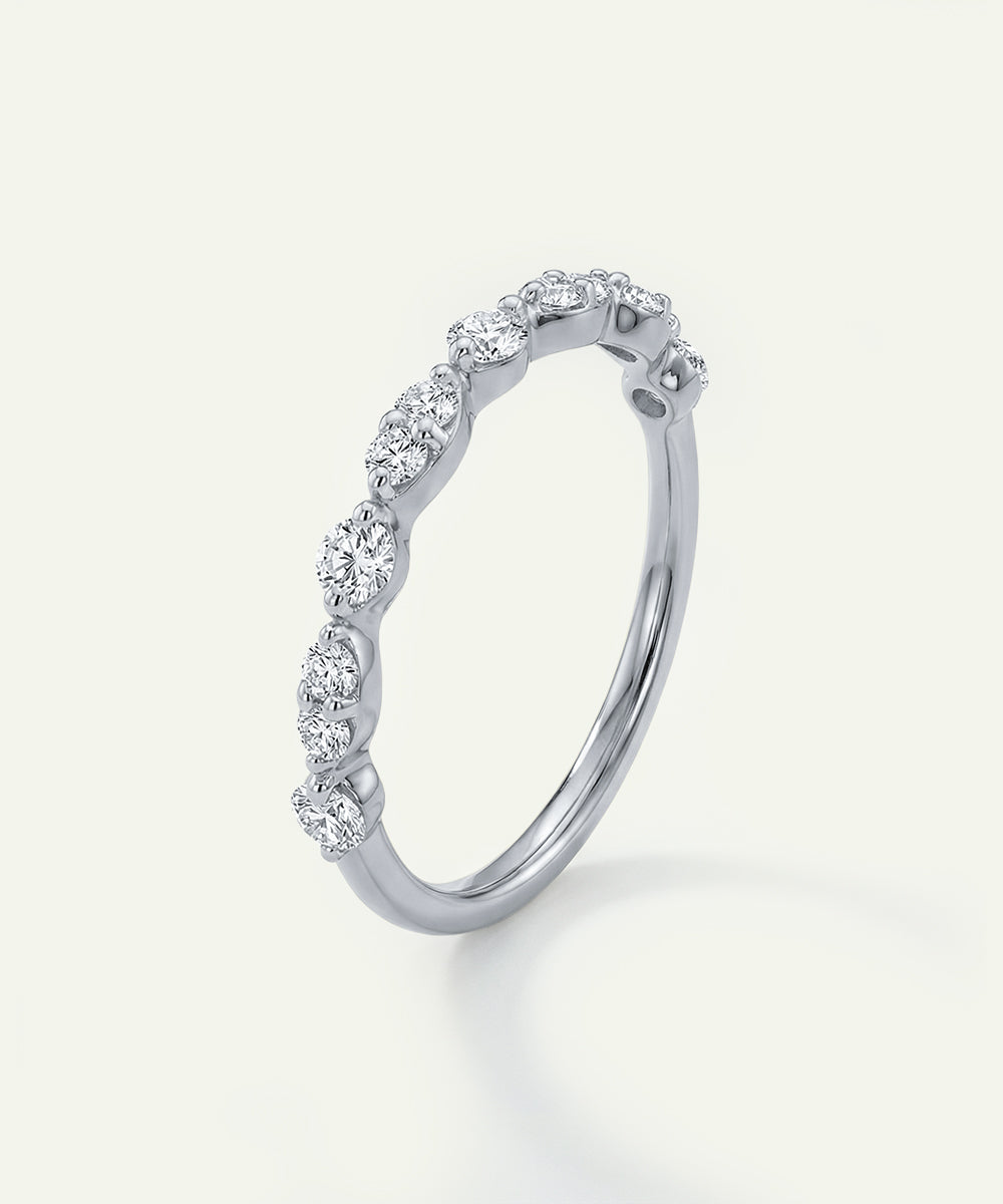 Silver ring with diamonds on a light gray background