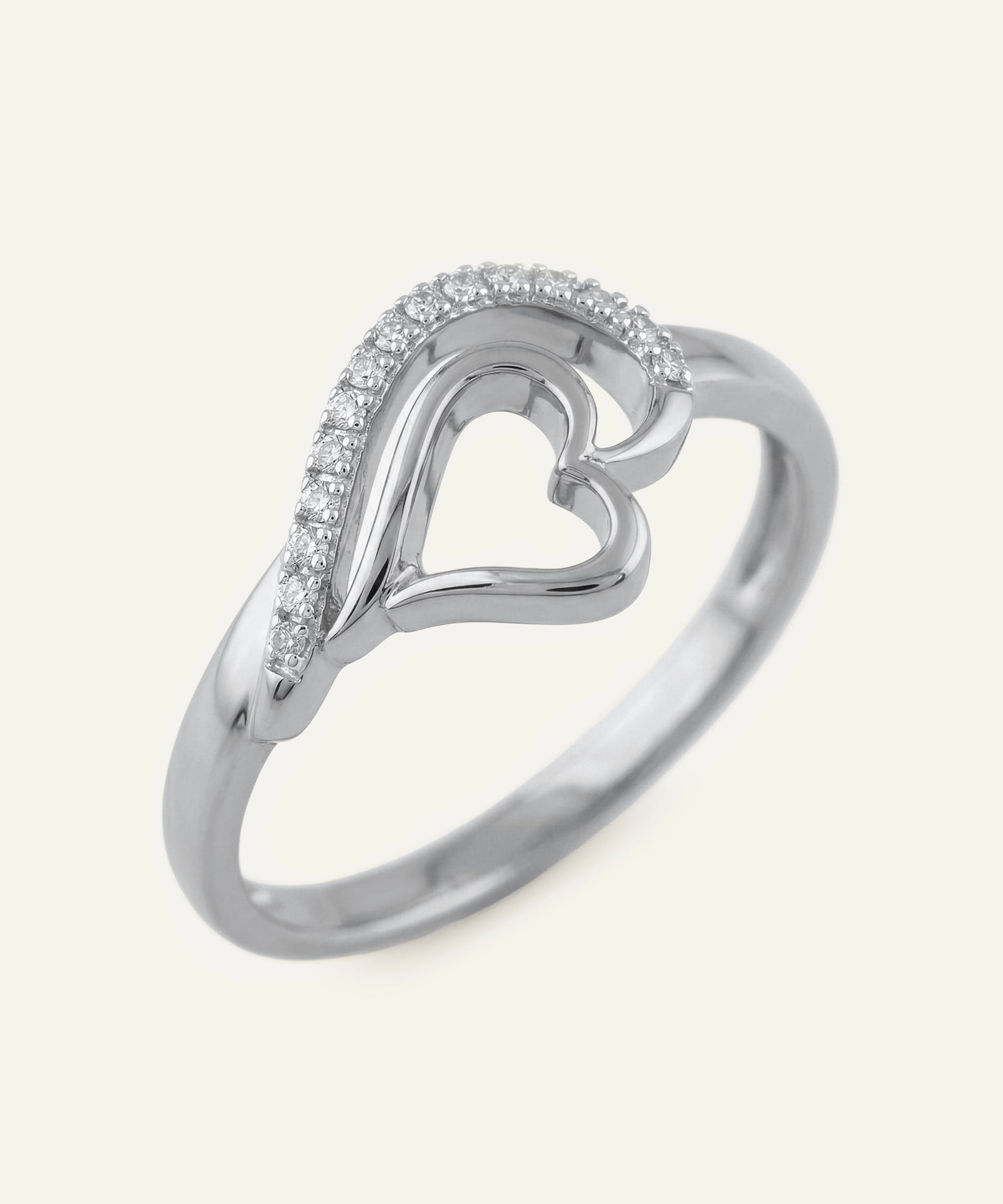 Silver heart-shaped ring with small diamonds on a white background