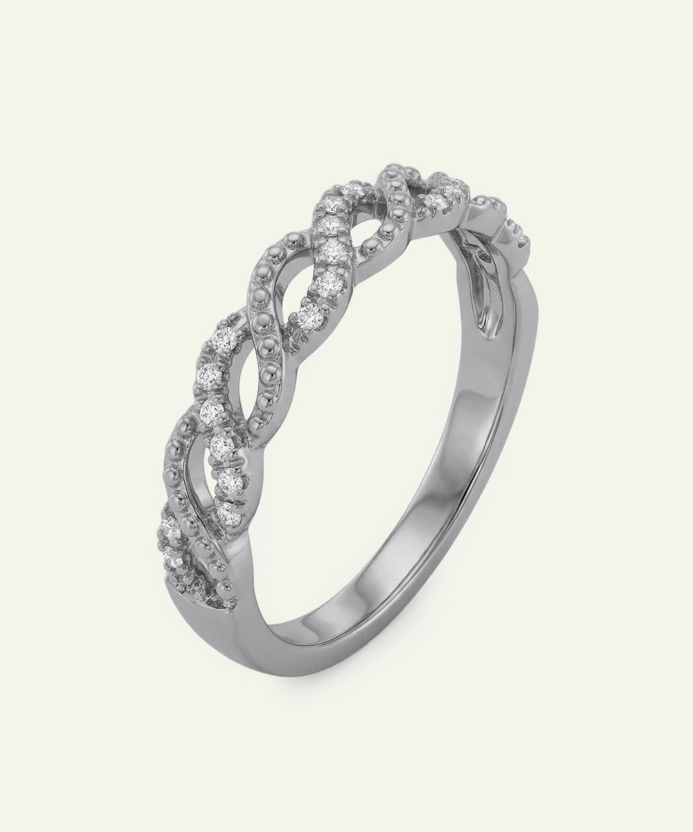 Silver ring with diamond accents on a light gray background